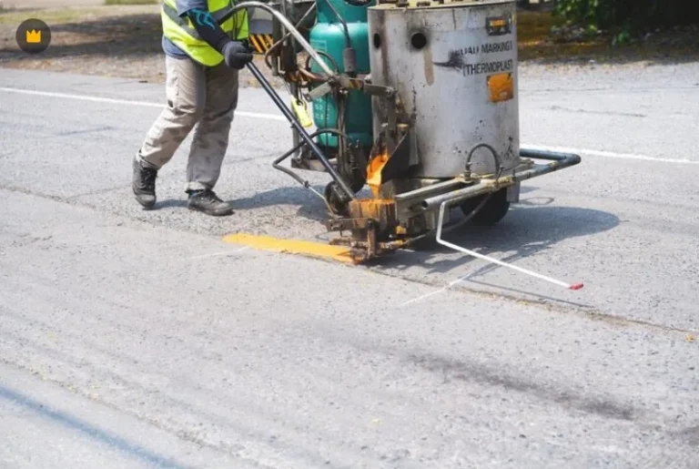 UniGulf Traffic crew applying hot thermoplastic road marking with a line marking machine in Doha, Qatar